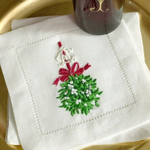 Mistletoe with red bow and 2 letter vintage monogram on white hemstitched linen cocktail napkins.