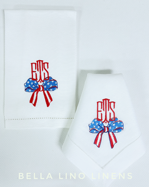 Stars and stripe bow with personalized monogram on linen napkins and pique linen guest towels.